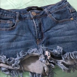 denim shorts; frayed at the bottom; a little short